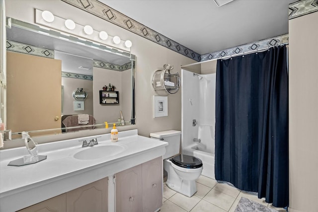 full bathroom featuring shower / tub combo with curtain, sink, tile patterned floors, and toilet