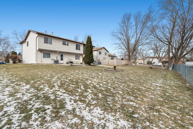 snow covered back of property with a yard