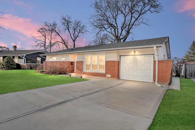 ranch-style house with a garage and a yard