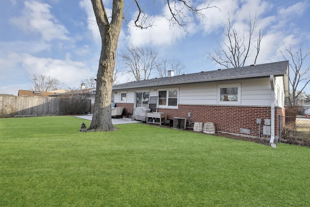 back of property featuring central AC unit and a lawn