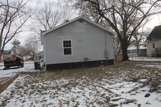 view of snowy exterior featuring cooling unit