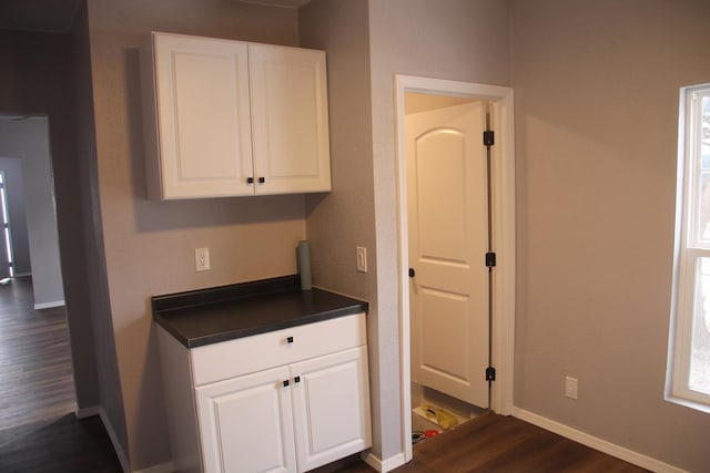 kitchen with white cabinetry and dark hardwood / wood-style flooring