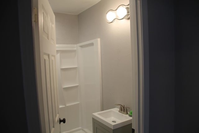 bathroom with vanity and a shower