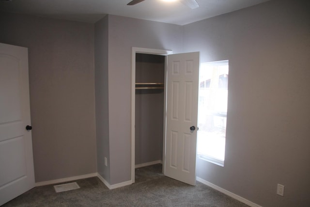 unfurnished bedroom with carpet floors, a closet, and ceiling fan