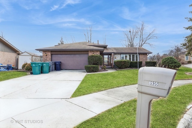 view of front facade featuring an attached garage, driveway, a front yard, and brick siding