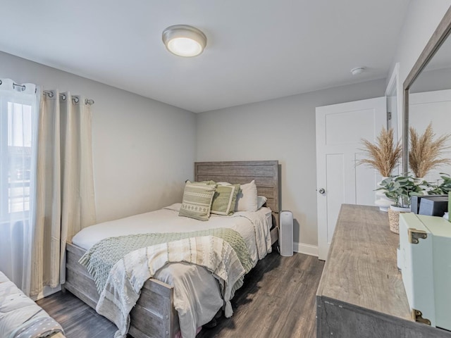 bedroom with dark wood-type flooring