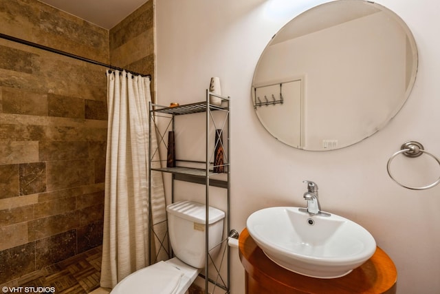 bathroom with toilet, parquet flooring, sink, and a shower with shower curtain