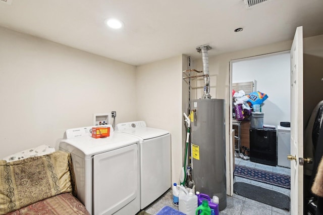 clothes washing area with gas water heater and washer and clothes dryer