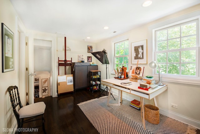 home office featuring plenty of natural light and dark hardwood / wood-style flooring