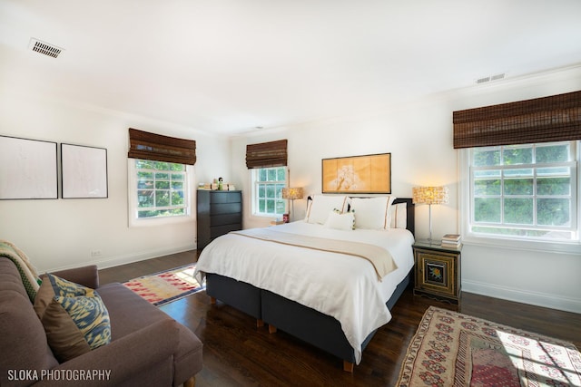 bedroom featuring dark wood-type flooring and ornamental molding