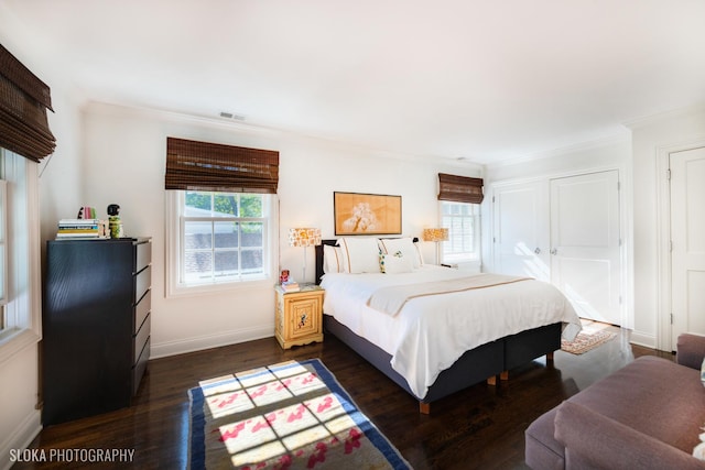 bedroom featuring dark wood-type flooring and crown molding