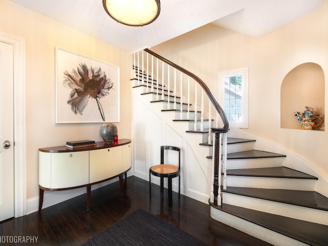 staircase with wood-type flooring