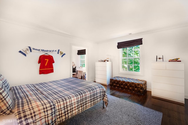 bedroom with crown molding and dark hardwood / wood-style flooring