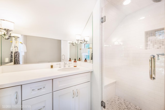 bathroom featuring a shower with door, vanity, and a notable chandelier