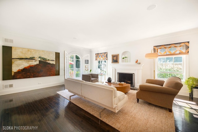 living room with ornamental molding and dark hardwood / wood-style floors