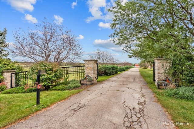 view of gate featuring a yard