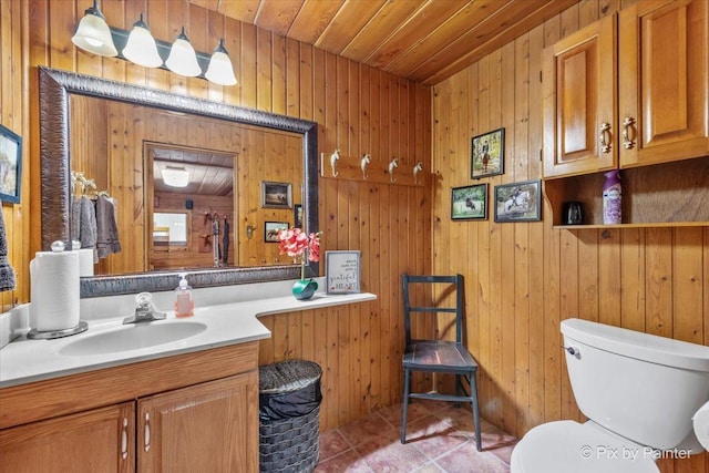 bathroom with wood walls, tile patterned floors, wooden ceiling, and vanity