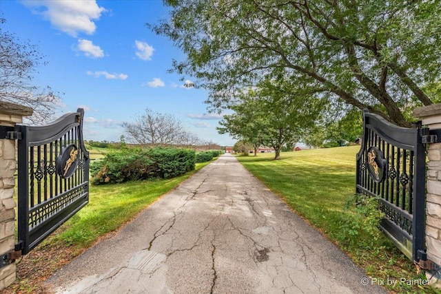 view of gate featuring a lawn