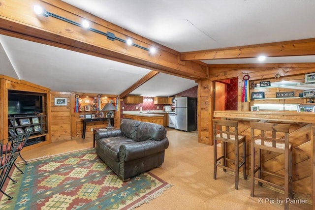 living room with light carpet, indoor bar, wood walls, and lofted ceiling with beams