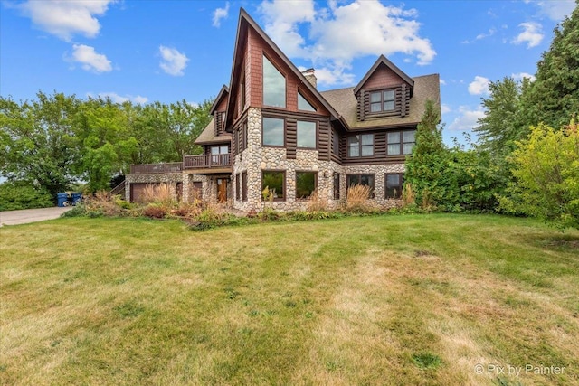 rear view of property featuring a lawn