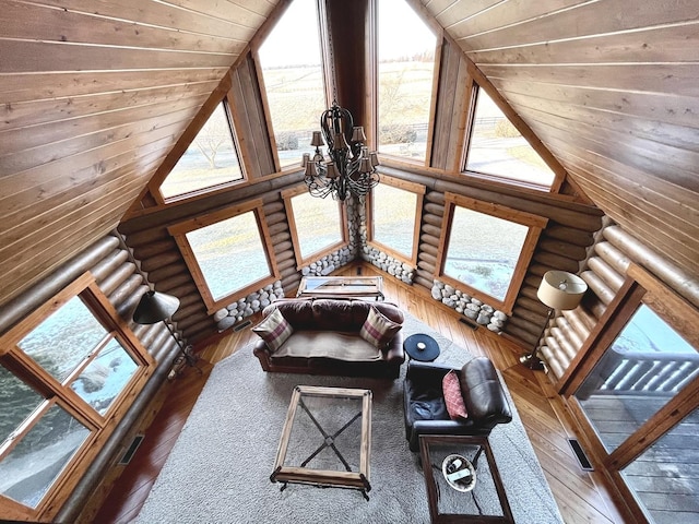 unfurnished living room with high vaulted ceiling, a wealth of natural light, rustic walls, and wood ceiling