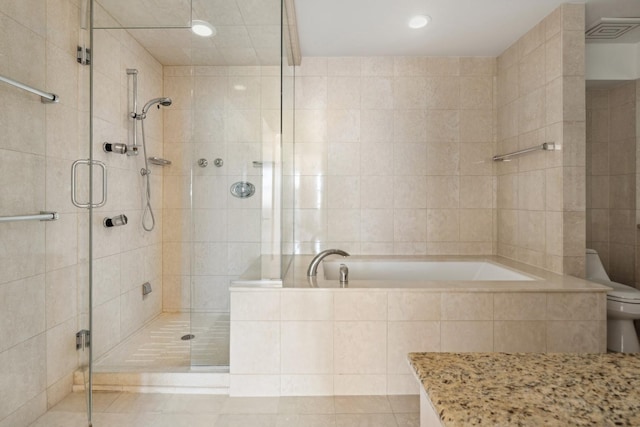 bathroom with tile walls, tile patterned floors, independent shower and bath, and toilet