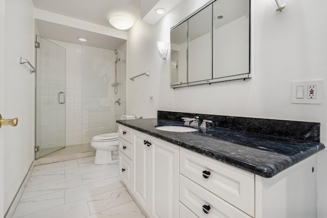 bathroom with vanity, toilet, and an enclosed shower