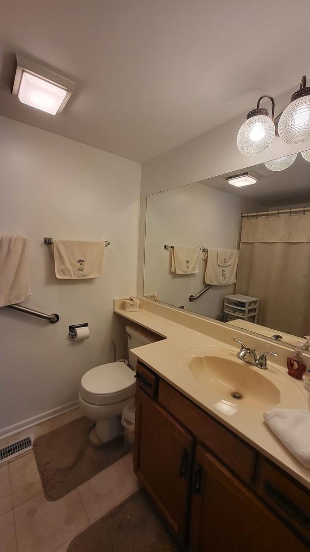 bathroom featuring toilet, tile patterned floors, a shower with shower curtain, and vanity