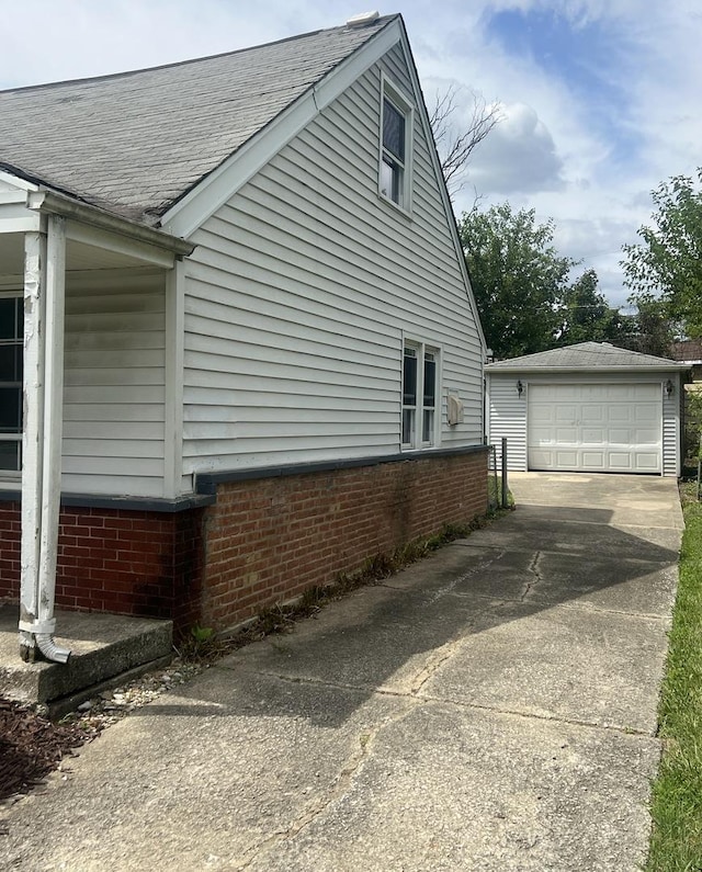 view of property exterior featuring a garage and an outbuilding