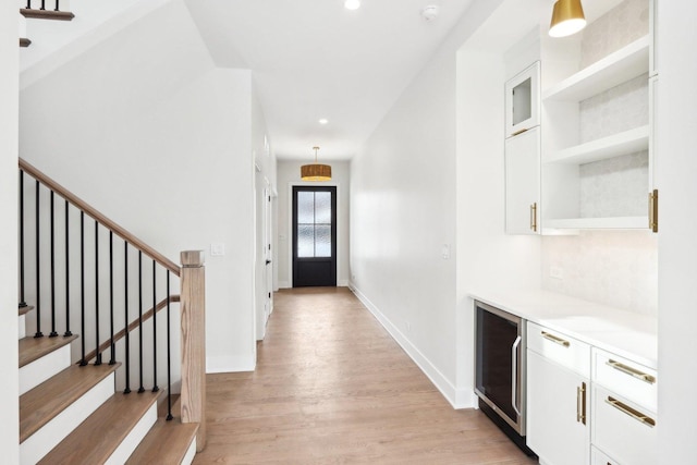 interior space featuring wine cooler and light hardwood / wood-style floors