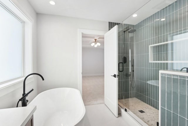 bathroom featuring shower with separate bathtub and a healthy amount of sunlight