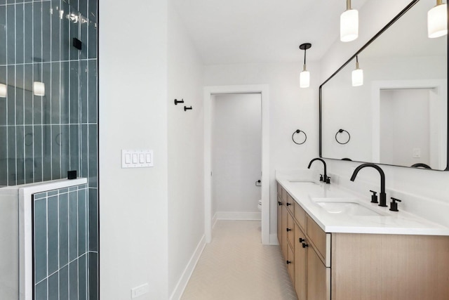 bathroom featuring vanity, tile patterned floors, and toilet