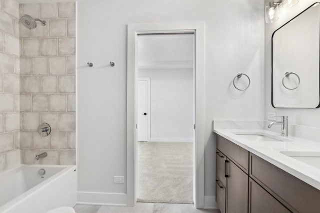 bathroom with vanity and tiled shower / bath combo