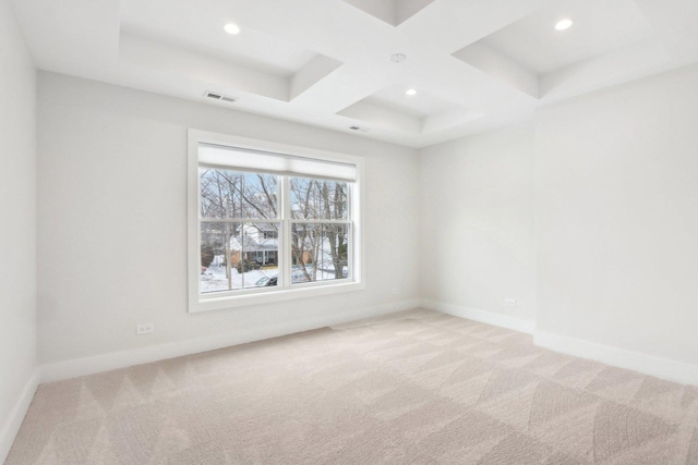 carpeted spare room with beamed ceiling and coffered ceiling