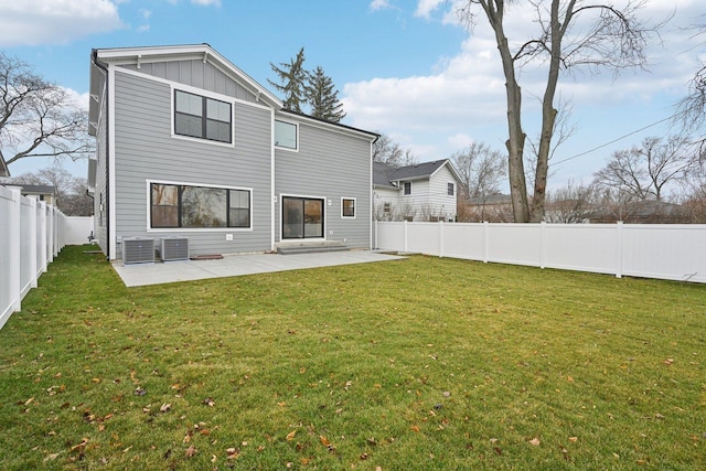 back of property featuring central air condition unit, a patio area, and a lawn