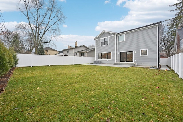 back of house with a yard, central AC, and a patio