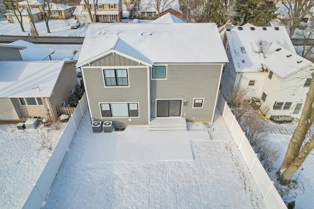 view of snow covered rear of property