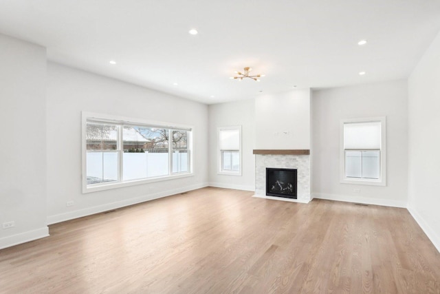 unfurnished living room featuring a fireplace and light wood-type flooring