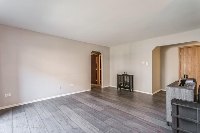 unfurnished living room with dark hardwood / wood-style floors