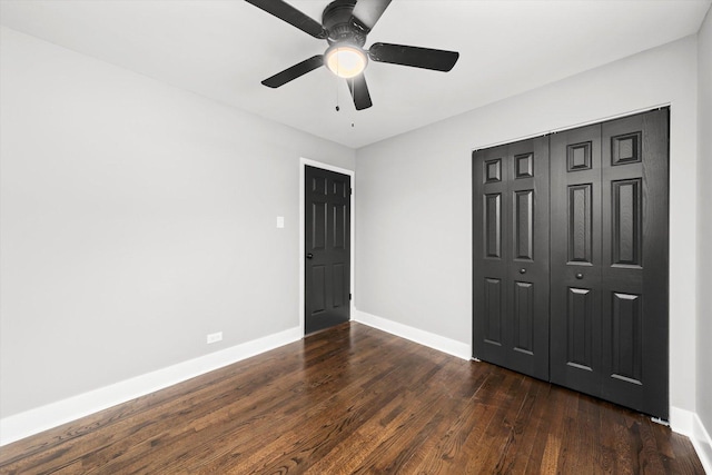 unfurnished bedroom featuring ceiling fan, dark hardwood / wood-style floors, and a closet