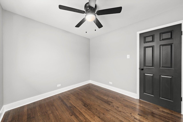 unfurnished room featuring ceiling fan and dark wood-type flooring