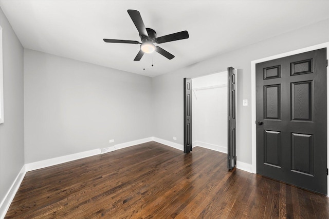 unfurnished bedroom featuring ceiling fan and dark wood-type flooring