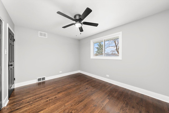 unfurnished room with ceiling fan and dark hardwood / wood-style flooring