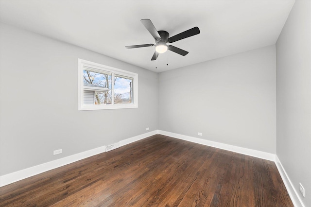 spare room with ceiling fan and dark hardwood / wood-style flooring