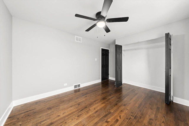 unfurnished bedroom with dark wood-type flooring and ceiling fan