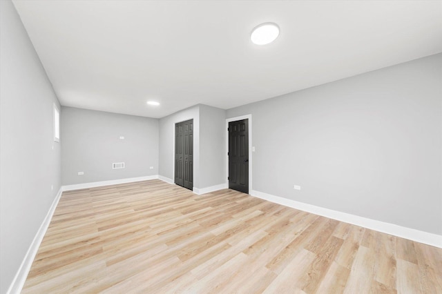 unfurnished room with light hardwood / wood-style floors