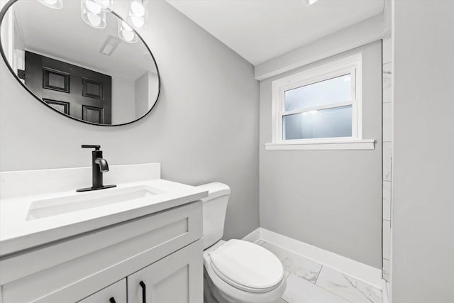 bathroom featuring toilet and vanity