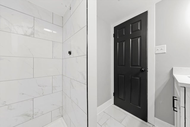 bathroom featuring vanity and tiled shower