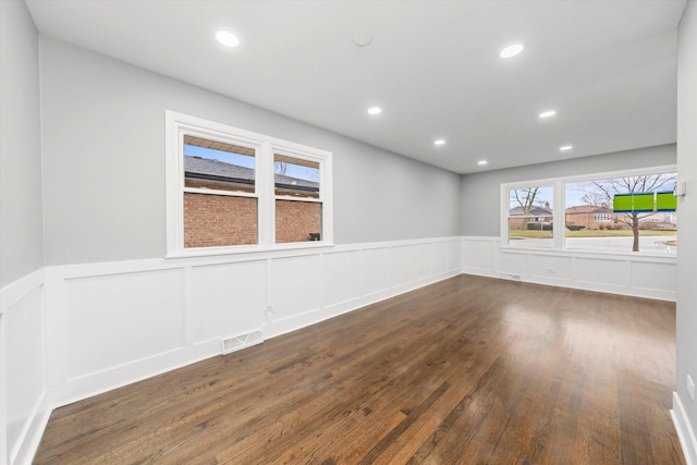 empty room with dark hardwood / wood-style flooring