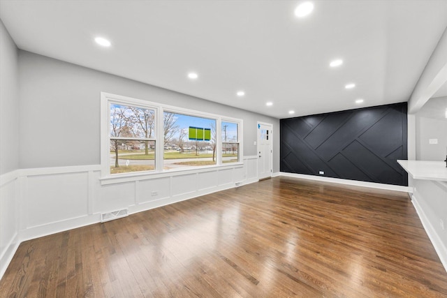 unfurnished living room featuring wood-type flooring